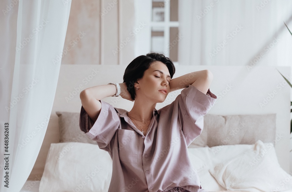 Gorgeous beautiful girl is in elegant pajamas is in bed. Natural female beauty. Gorgeous beautiful girl is in elegant pajamas is in bed. Natural female beauty.