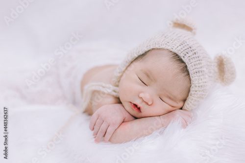 Cute smile baby lying on the white blanket.