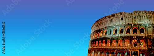 Photography Banner with front view of wonderful ancient Colosseum at night illumination and sunset blue and green sky background with copy space, Rome, Italy