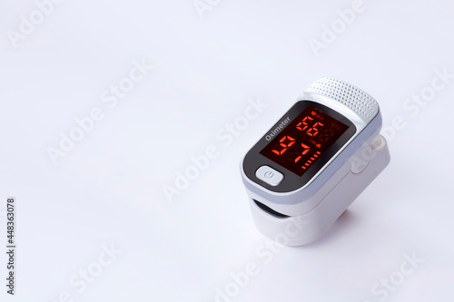 Portable pulse oximeter device on white background, Measurement of blood oxygen level and pulse photo