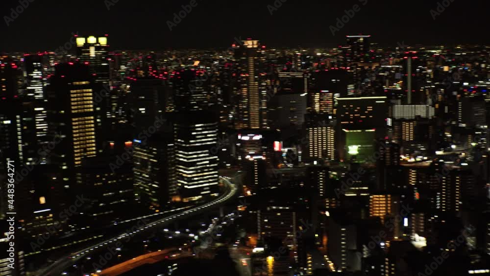 UMEDA, OSAKA, JAPAN : Aerial high angle view of CITYSCAPE of OSAKA at night. View of buildings and street around Osaka and Umeda station. Wide view real time shot. UMEDA, OSAKA, JAPAN : Aerial high angle view of CITYSCAPE of OSAKA at night. View of buildings and street around Osaka and Umeda station. Wide view real time shot.