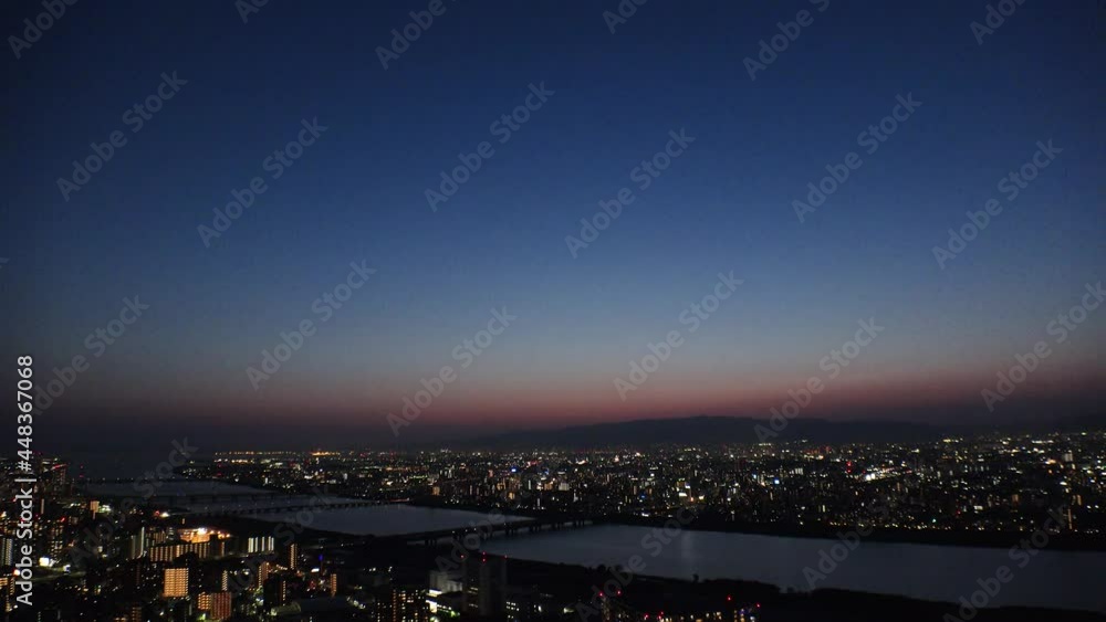 OSAKA, JAPAN : Aerial high angle view of CITYSCAPE of OSAKA at night. View of buildings and street traffic around Yodogawa river. Wide view real time shot. OSAKA, JAPAN : Aerial high angle view of CITYSCAPE of OSAKA at night. View of buildings and street traffic around Yodogawa river. Wide view real time shot.