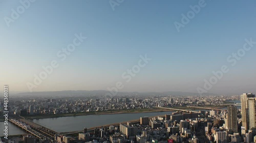 OSAKA, JAPAN : Aerial high angle sunset view of CITYSCAPE of OSAKA. View of buildings and street traffic around Yodogawa river. Wide view real time shot in dusk.  photo