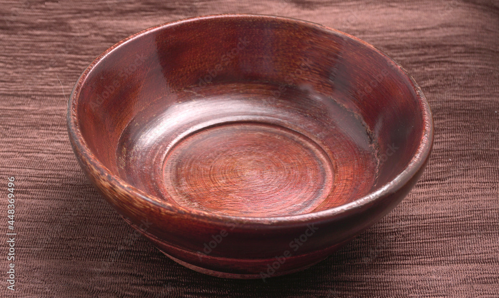 Empty wooden bowl and wooden spoon isolated with copy space. Empty wooden bowl and wooden spoon isolated with copy space.