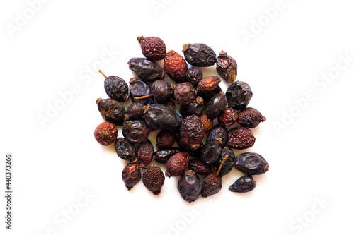 Fotografi Pile of dried rose hips isolated on white background, top view