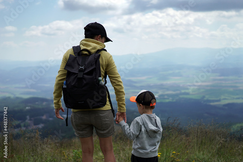 Young female tourist standing with her son and enjoying beautiful view in the mountains, Slovakia, High Tatras 