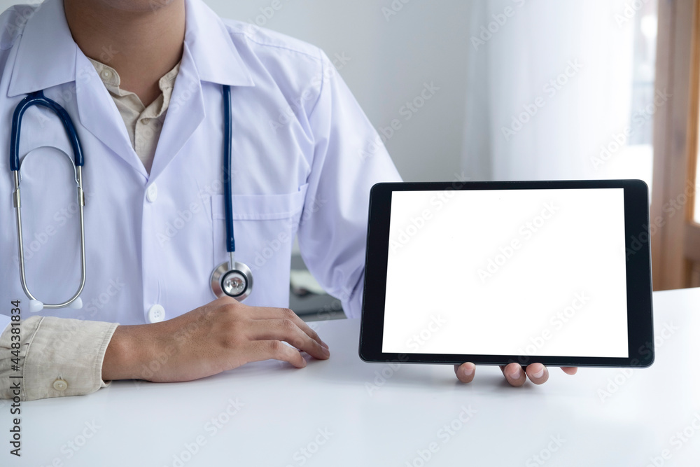 Doctor using computer tablet discussion something with patient.