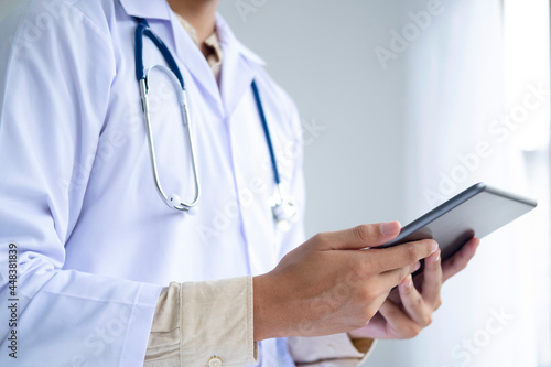 Doctor using a digital tablet computer at work.