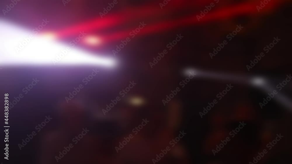 Neon lights on the dance floor. Slow time. Blurry bokeh. People are jumping on the dance floor and waving their hands. Entertainment, background and party concept Neon lights on the dance floor. Slow time. Blurry bokeh. People are jumping on the dance floor and waving their hands. Entertainment, background and party concept