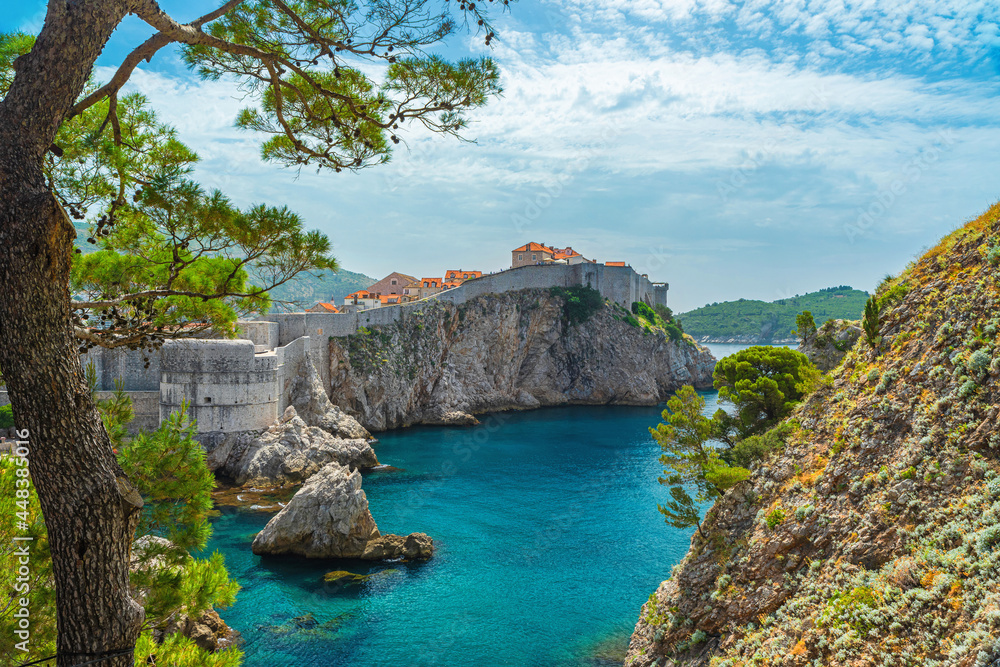 View Dubrovnik old town with city walls, fort Bokar and blue waters of Adriatic sea. Famous european travel destination in Croatia