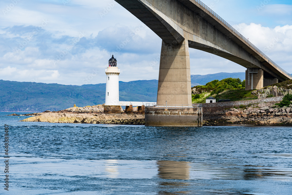 The Scottish Skye Road Bridge as it connects to the small island Eilean Ban in Loch Alsh, Scotland, UK.  Also shown is the Kyleakin Lighthouse