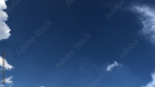 Timelapse of White Cumulus Clouds Changing Shape In Blue Sky With Green Trees