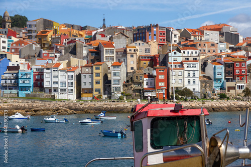 Partial view of the tourist town of La Guardia (A Guarda) in front of the port with boats in the water. Galicia. Spain