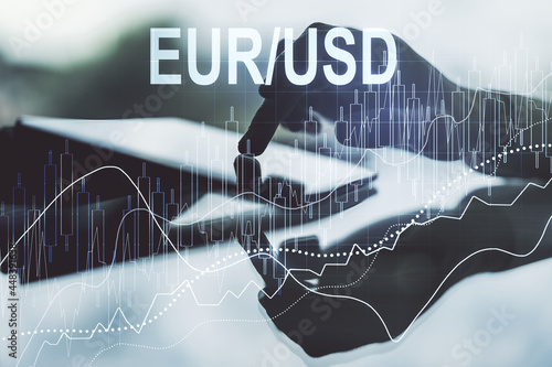 Creative concept of EURO USD financial chart illustration and finger clicks on a digital tablet on background. Trading and currency concept. Multiexposure