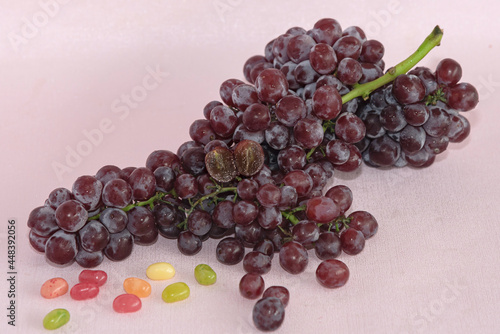 Ripe candy snaps grape fruit put in pink steel basket.pink background.