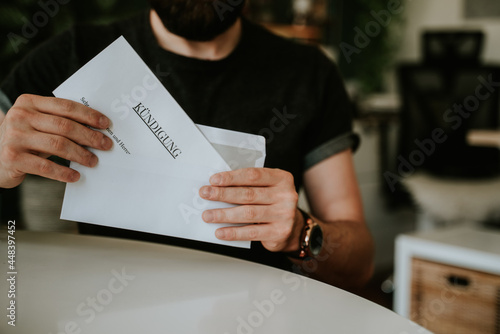 Young Man in black T-Shirt packing a resignation letter