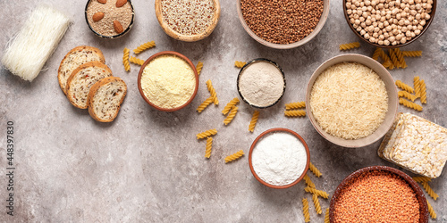 Selection of gluten free food on a rustic background. A variety of grains, flours, pasta, and bread gluten-free. Top view, flat lay,wide composition.