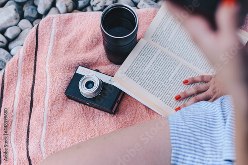 Person reading a book on a beach