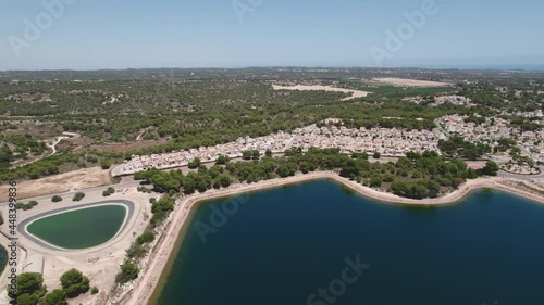 Wide angle drone point of view coastline and sandy beach of Pinar de Campoverde town with surrounding countryside at sunny summer day. Province of Alicante, south of Spain photo