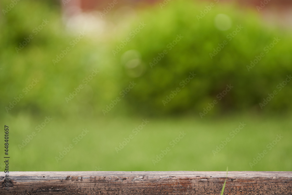 Fototapeta premium Horizontal template for the layout, banner. Wooden pedestal on a green background. A flat rectangular stand or podium for a natural design concept. . High quality photo