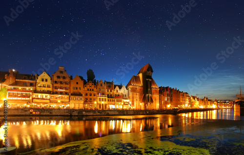 Night view of the old crane and the old town of Gdansk City photo