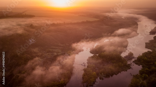 amazing aerial view of foggy morning river and colorful trees. drone shot