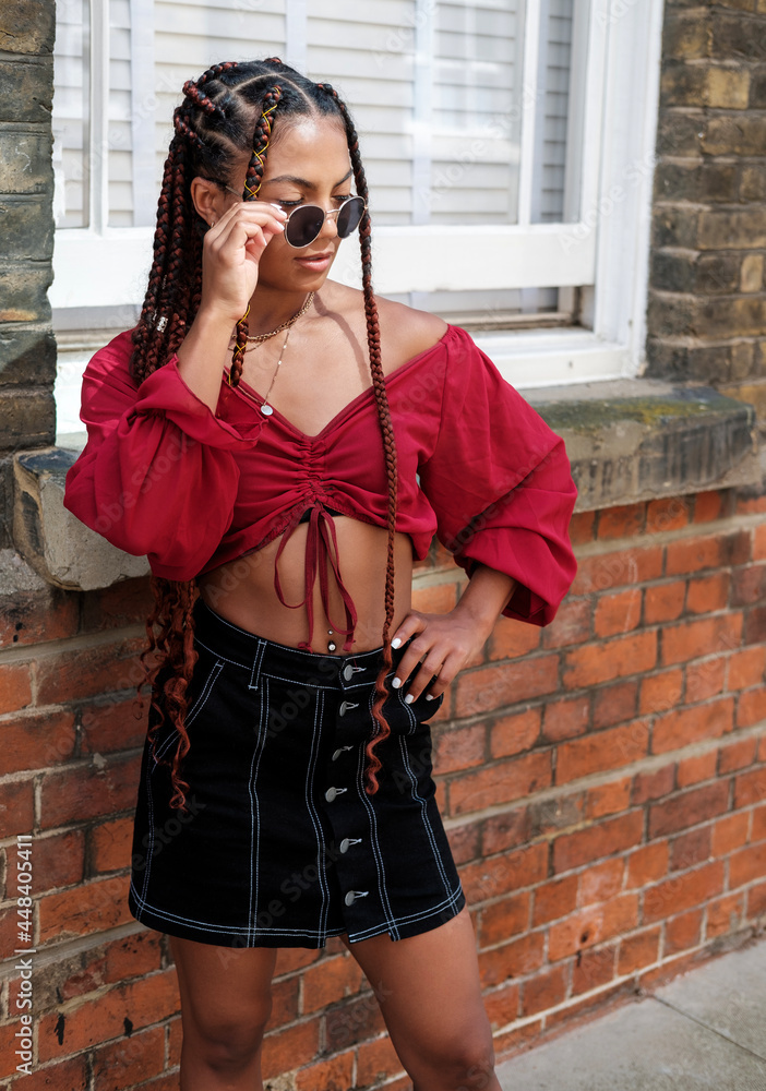 Young woman with cool hair and sunglasses posing. Young woman with cool hair and sunglasses posing.