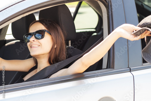 road travel, teenager summer car trip and happy vacation, holidays with friends, girl driver in sunglasses travels in a rented auto © yta