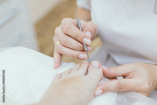 Professional pedicure. Client on medical pedicure procedure. Podiatry clinic. Podology. Healthcare. Close-up. Selective focus. Shallow depth of field.