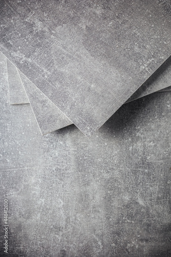 Abstract grey background texture at table or wall surface. Gray piece of chipboard