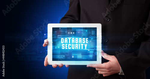 Wallpaper Mural Person holding tablet, security concept Torontodigital.ca