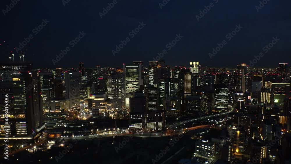 UMEDA, OSAKA, JAPAN : Aerial high angle sunrise view of CITYSCAPE of OSAKA. View of buildings and street around Osaka and Umeda station. Wide view time lapse shot, night to morning. UMEDA, OSAKA, JAPAN : Aerial high angle sunrise view of CITYSCAPE of OSAKA. View of buildings and street around Osaka and Umeda station. Wide view time lapse shot, night to morning.