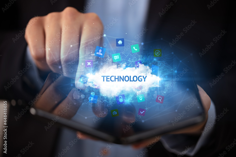 Businessman holding a foldable smartphone, technology concept Businessman holding a foldable smartphone, technology concept