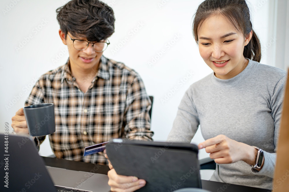 Asian people using tablet and credit card for online payment, E-commerce.