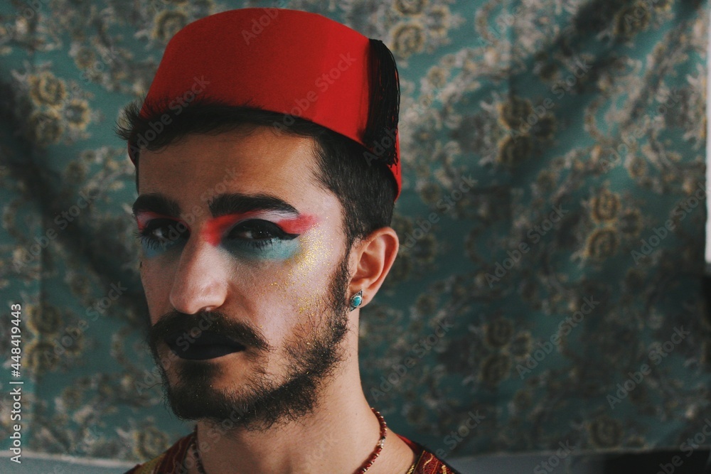Portrait of queer young man with full face drag makeup & turkish anatolian ottoman traditional clothing with authentic patterns background *4 - obrazy, fototapety, plakaty 