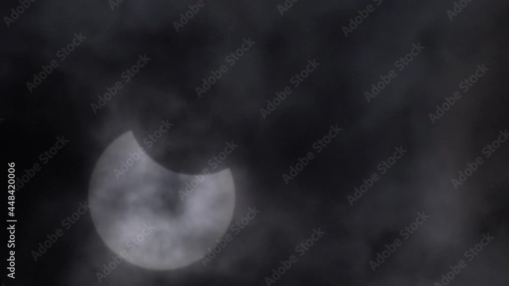 Eclipse of the moon behind the clouds dramatic movie. Cinematic blurred environment. Hot air vibrates for an eclipse of the moon. The clouds cover the moon Eclipse of the moon behind the clouds dramatic movie. Cinematic blurred environment. Hot air vibrates for an eclipse of the moon. The clouds cover the moon
