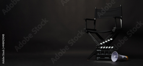 Black director chair and Clapper board or movie Clapperboard with megaphone on black background.use in video production or film cinema industry © nisara