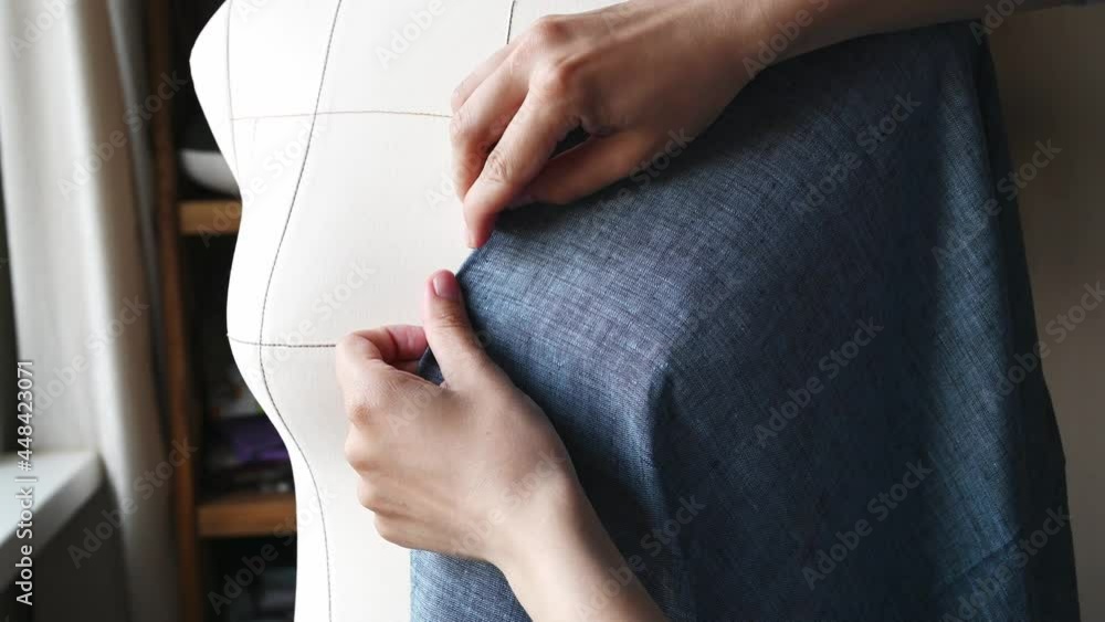 Designer fits fabrics on dressmaker's dummy. Clothes designing concept. Designer fits fabrics on dressmaker's dummy. Clothes designing concept.