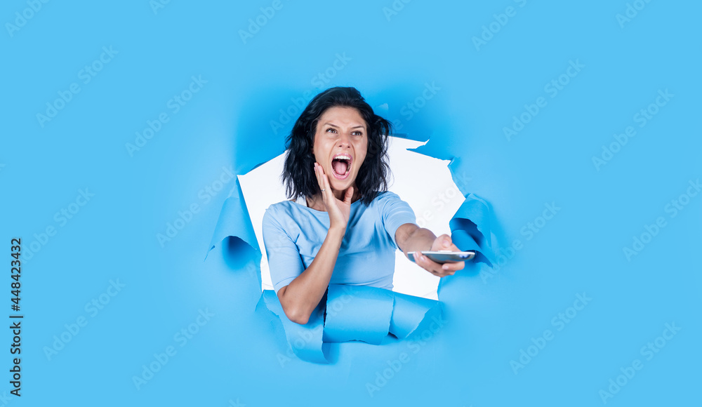 rejoicing at positive news. technology in modern life. portrait of caucasian female with brunette hair. turn on the tv. girl feeling happiness. happy young woman using remote control rejoicing at positive news. technology in modern life. portrait of caucasian female with brunette hair. turn on the tv. girl feeling happiness. happy young woman using remote control