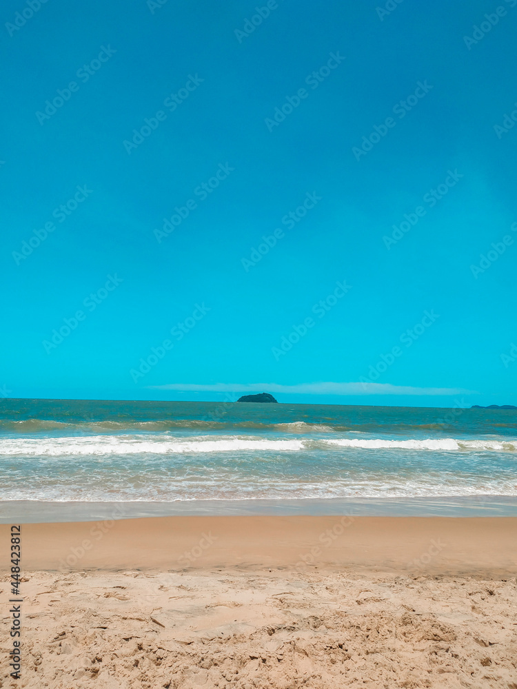beach with blue sky, sand and island