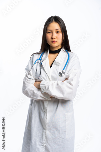 portrait of a girl in a black dress and a white medical gown with long black hair on a white background. young specialist  doctor