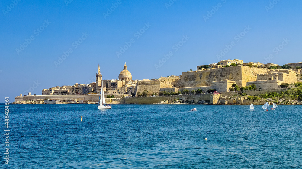 Sailing boats in Marsamxett Harbour in front of the fortifications of the City of Valletta., Malta.