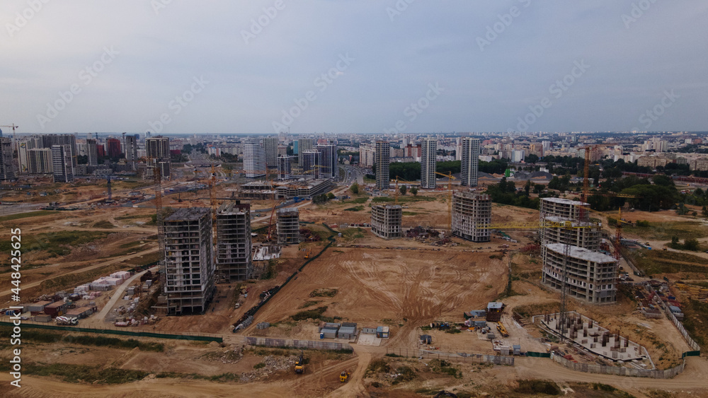 Construction site for a new city block. Construction work is underway. The constructed buildings are visible. Aerial photography.