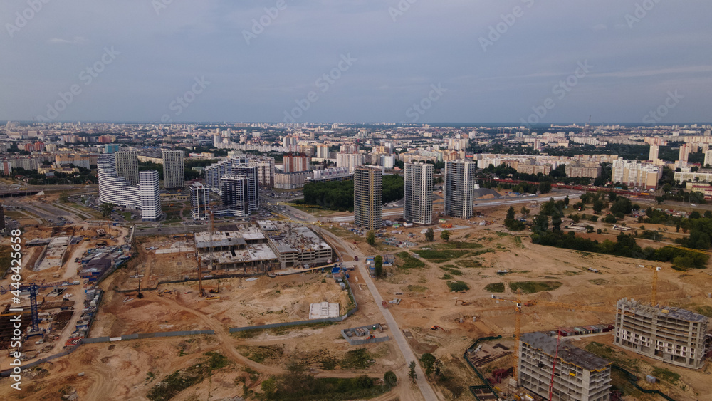 Construction site for a new city block. Construction work is underway. The constructed buildings are visible. Aerial photography.