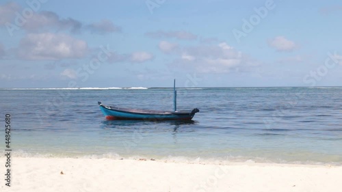 A boat at the sea near the coast on tropical island photo
