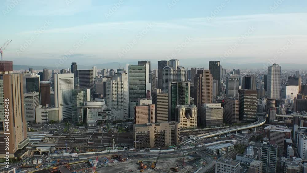 UMEDA, OSAKA, JAPAN : Aerial high angle sunset view of CITYSCAPE of OSAKA. View of buildings and street around Osaka and Umeda station. Wide view time lapse shot, dusk to night. UMEDA, OSAKA, JAPAN : Aerial high angle sunset view of CITYSCAPE of OSAKA. View of buildings and street around Osaka and Umeda station. Wide view time lapse shot, dusk to night.