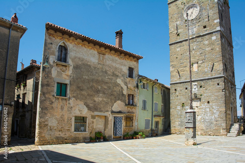 Trg Sv Servula square in the historic medieval village of Buje in Istria, Croatia. The square is named after the church which stands there, St Servulus, the clock tower of which is on the right
 photo