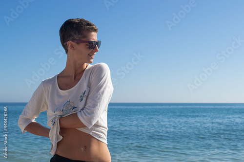 Woman posing on the beach.