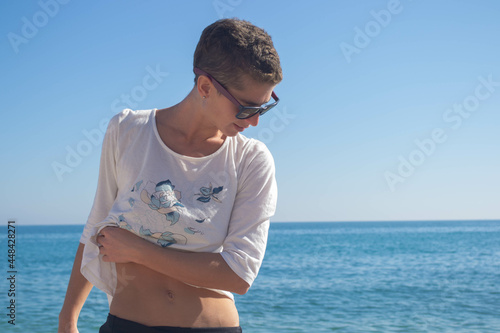 Woman posing on the beach.