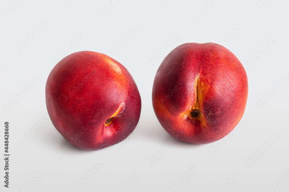 Two ripe, juicy nectarines with a delicate velvety skin Two ripe, juicy nectarines with a delicate velvety skin
